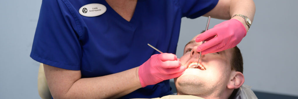 A Friends in Need dental hygienist caring for a patient